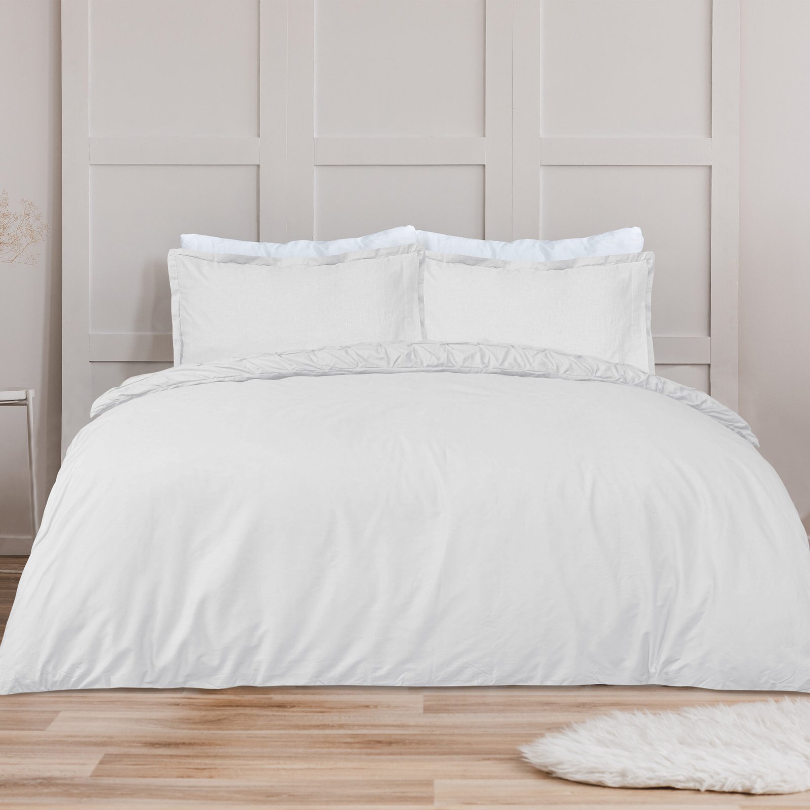 White pillow on blue bedding on king size bed in fashionable bed