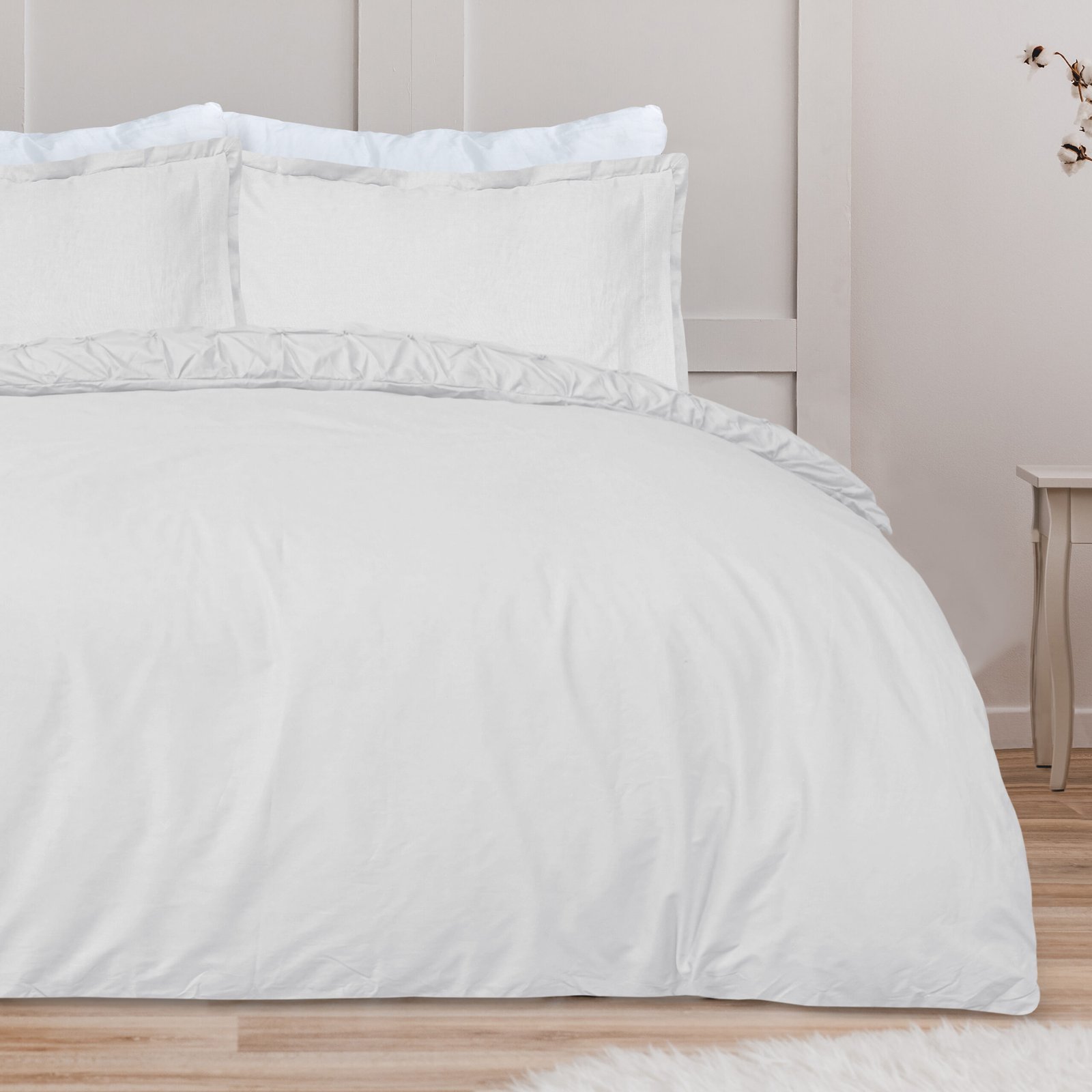 White pillow on blue bedding on king size bed in fashionable bed