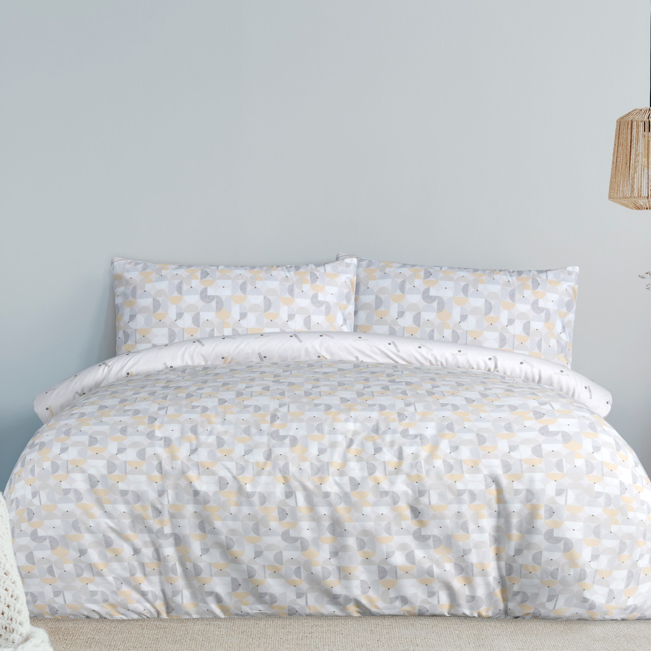 Warm blanket on white duvet in cozy bedroom interior Geo