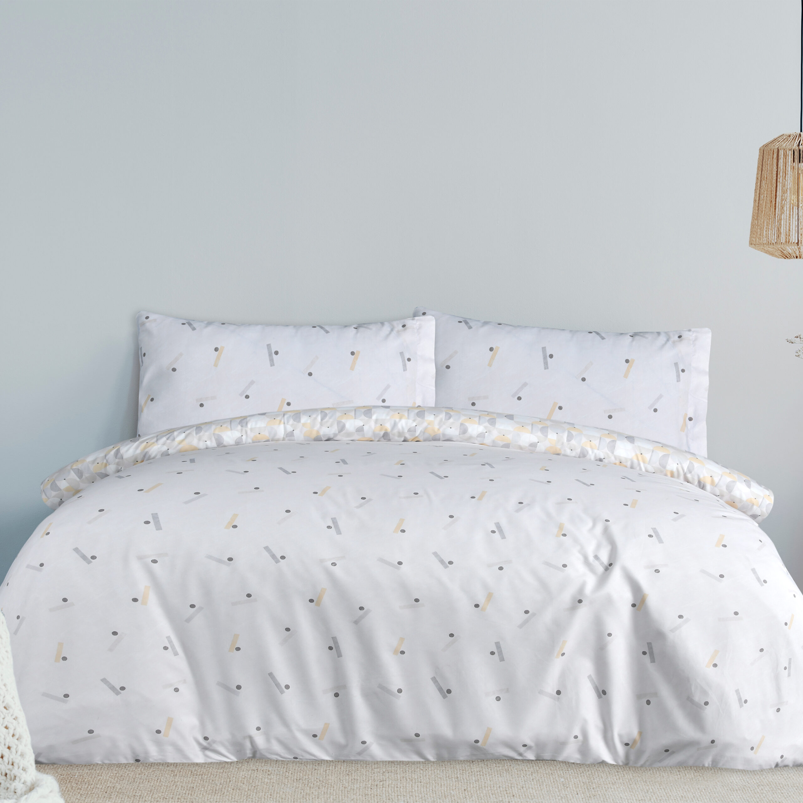 Warm blanket on white duvet in cozy bedroom interior